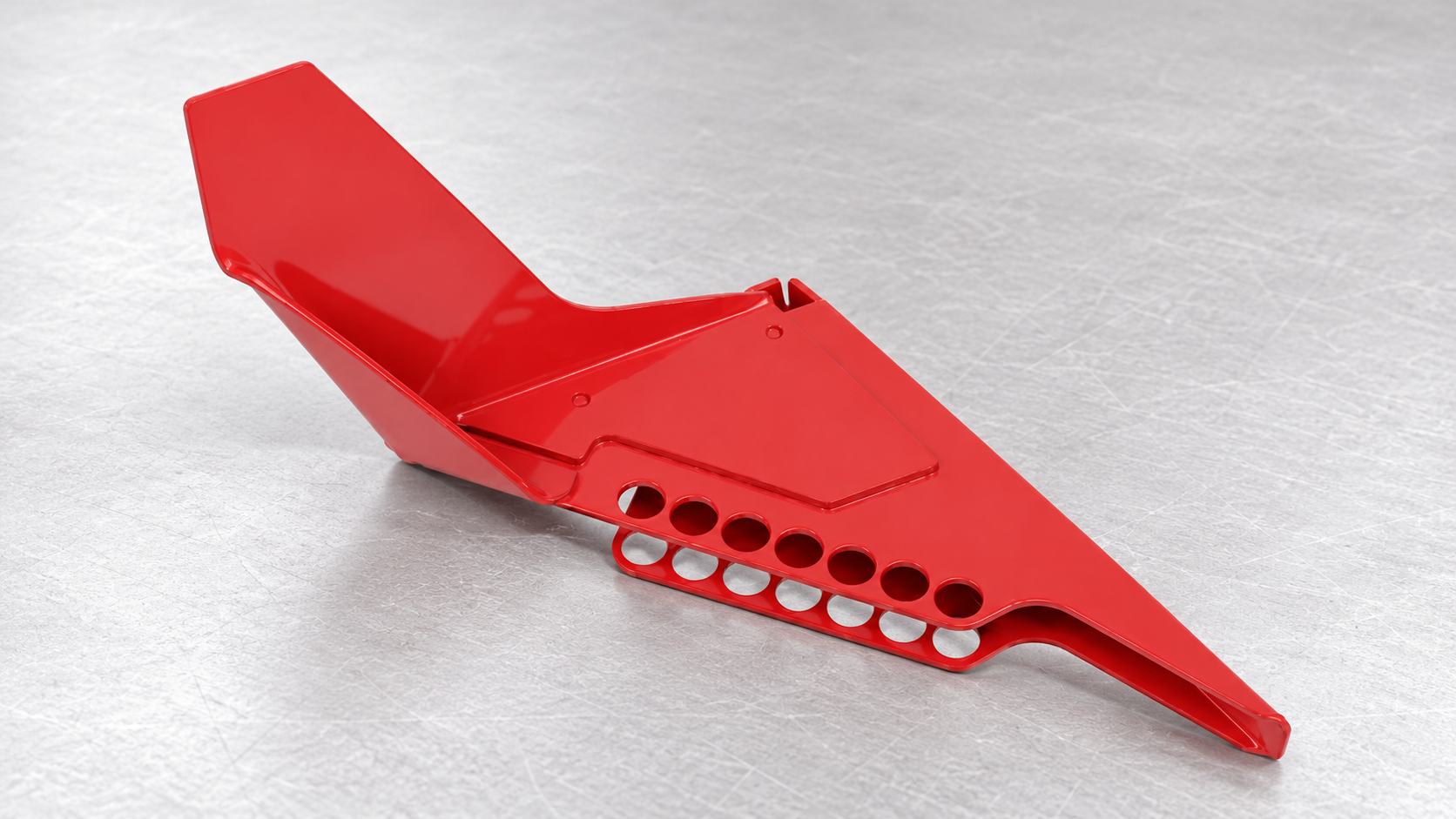 Red steel hand-rod valve-lockout device with a formed wedge and padlock-positioning holes on an inspection bench.